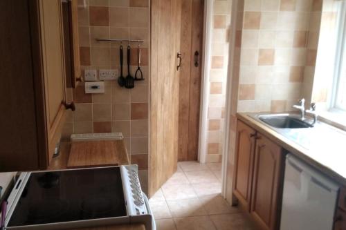 a kitchen with a sink and a counter top at Welcoming cottage in Chichester near City Centre in Chichester