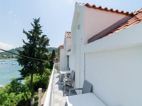 a balcony with chairs and a view of the water at Holiday Home Macus in Koločep