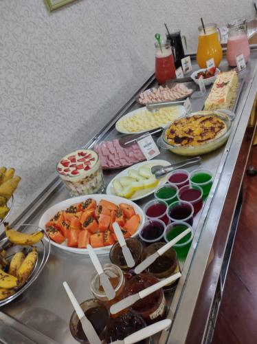 a buffet line with many different types of food at Nova Vicenza Hotel in Farroupilha