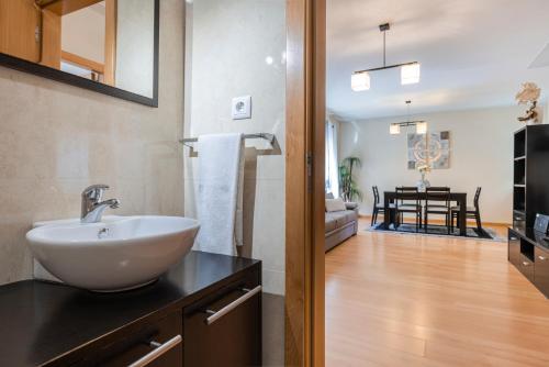 a bathroom with a sink and a kitchen with a dining room at Casa no Sitio in Nazaré