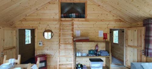 a cabin with wooden walls and a ceiling at The Willow Cabin - Wild Escapes Wrenbury off grid glamping - ages 12 and over in Wrenbury
