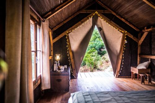 a bedroom with a bed with a drape in it at Quinta Alma - Ecological Retreat Farm in Aljezur