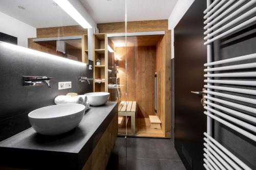 a bathroom with two sinks on a black counter at Penthouse Feldberg in Feldberg