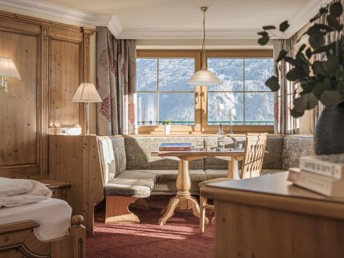 a living room with a couch and a table at Platzlhof - Mein Hotel im Zillertal in Ried im Zillertal