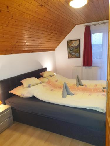 a bedroom with a large bed in a room at Vilmos Pince Fogadó in Hévíz