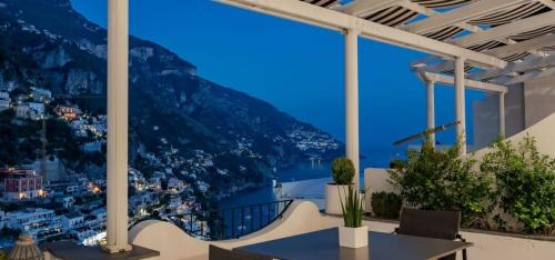 a view of a city from a balcony at night at Hotel Villa Franca in Positano