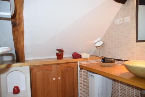 a kitchen with a counter with a sink and a counter at Le four à pain in Najac