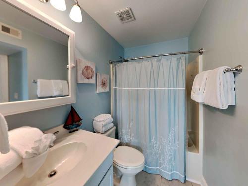 a bathroom with a toilet and a sink and a shower at Dory #D in Perdido Key