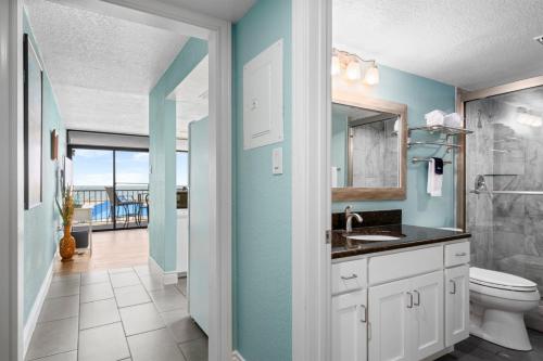 a bathroom with a sink and a toilet with a view at Laguna Reef #211 - Rod and Reel in Rockport