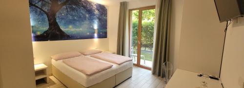 a small bedroom with a bed and a window at Agriturismo Vin e Amor in Dro