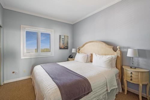 a bedroom with a large bed and a window at The Hermitage at Napeague in Amagansett