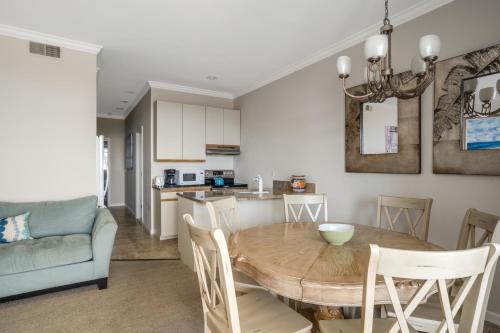 a kitchen and dining room with a table and chairs at The Hermitage at Napeague in Amagansett