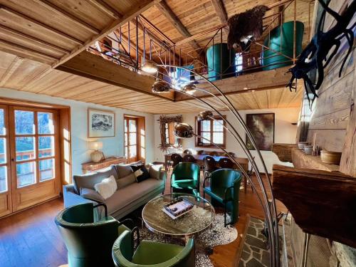 a living room with a couch and a table and chairs at Chalet Altus in Sainte-Foy-Tarentaise