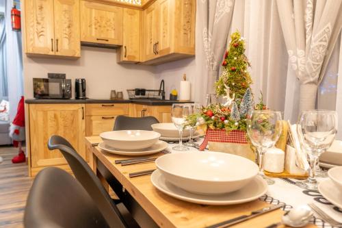 a kitchen with a table with a christmas tree on it at Modrzewiowa Ostoja II in Kluszkowce