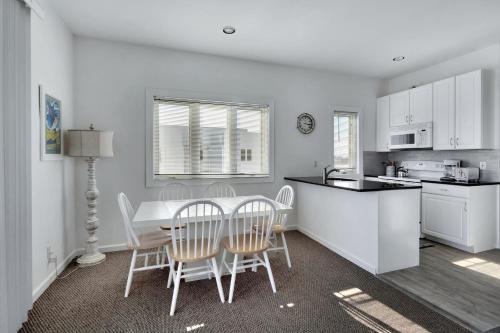 a kitchen and dining room with a table and chairs at The Hermitage at Napeague in Amagansett