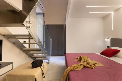 a bedroom with a bed and a staircase at CASA LUCKY CENTRAL APARTMENT in Piano di Sorrento
