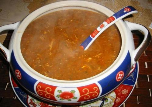 a pot of soup with a spoon in it at Chegaga Desert Trips in Mhamid