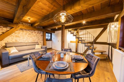 a dining room with a table and chairs and a couch at Außergewöhnliche Übernachtung im Wehrturm in Bad Hersfeld