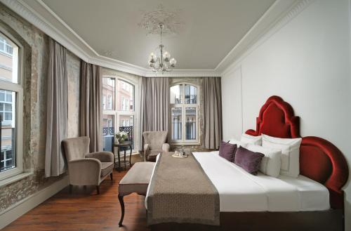 a bedroom with a large bed and a living room at Meroddi Galata Flats in Istanbul