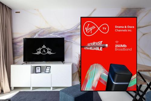 a booth with a tv on a stand next to a sign at Work-Ready Apartment - Reliable and Relaxing - Apartment 3 in Gillingham
