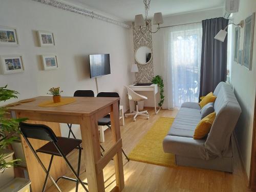 a living room with a table and a couch at Studio Apartment TIM in Zagreb