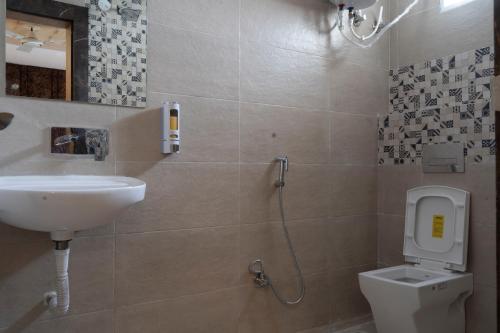a bathroom with a sink and a toilet at Hotel Sohrai Inn in Rānchī