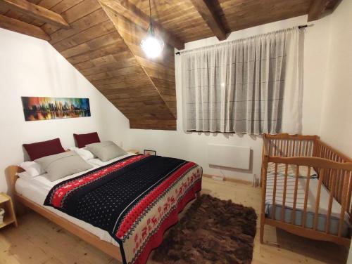 a bedroom with a bed and a wooden ceiling at Apartmani Pahulja in Jahorina