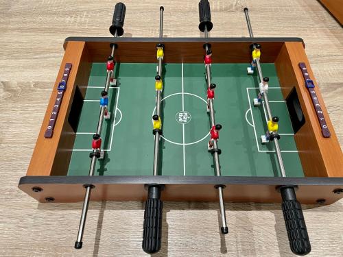 a table with people playing a soccer game on it at Friendly Bean in Cachan