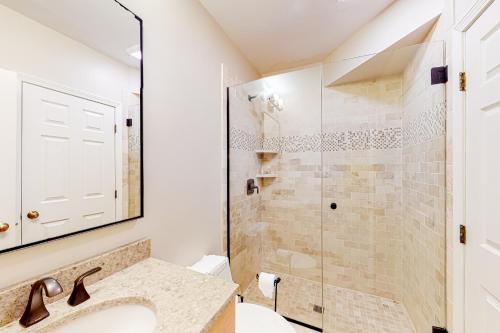 a bathroom with a sink and a shower at Winterplace Condos K in Ludlow