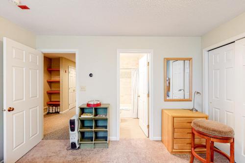 a room with a door and a stool and a table at Winterplace Condos K in Ludlow