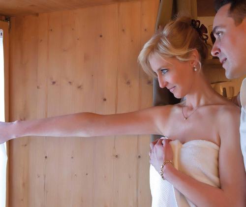 a bride and groom standing next to each other at Baita Luleta in Livigno