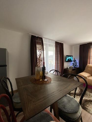 a living room with a wooden table and chairs at Vila Luka i Ana - Apartman Luka in Zaovine