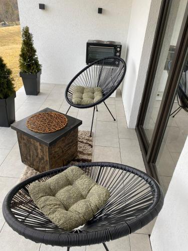a patio with two chairs and a bench and a table at Vila Luka i Ana - Apartman Luka in Zaovine