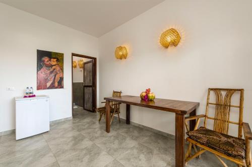 a dining room with a table and a chair at Surfescape Zanzibar in Kiwengwa