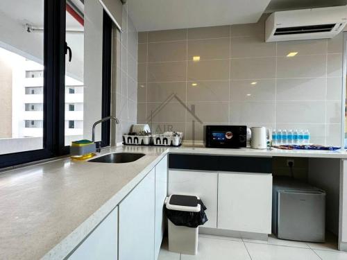 a kitchen with a sink and a counter top at PD D'Wharf Duplex 3BR - Full Seaview (Up To 12 Pax) in Port Dickson