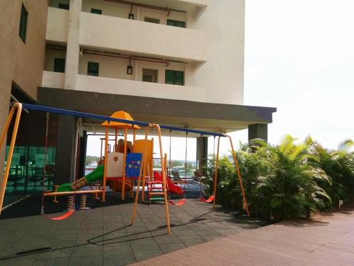 a playground in front of a building at PD D'Wharf Duplex 3BR - Full Seaview (Up To 12 Pax) in Port Dickson