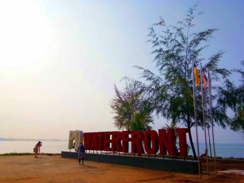 a man standing in front of a sign that readspotion at PD D'Wharf Duplex 3BR - Full Seaview (Up To 12 Pax) in Port Dickson