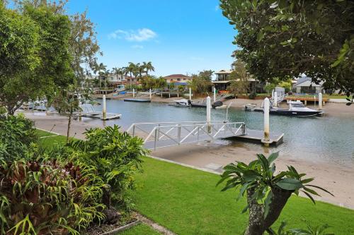 a dock with boats in a body of water at Fantastic Buddina Duplex in Buddina