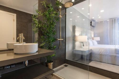 a bathroom with a sink and a bed at Seaview Luxury Apartment in Cascais