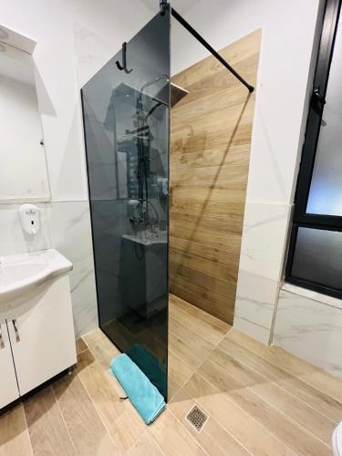 a bathroom with a shower and a sink at Colombia Apartments&Rooms in Durrës