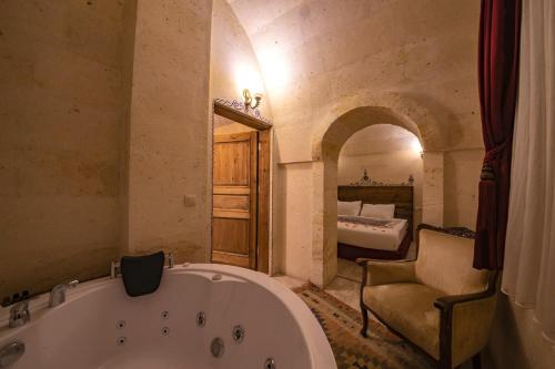 a large bathroom with a tub and a bedroom at Corner in Cappadocia in Nevsehir
