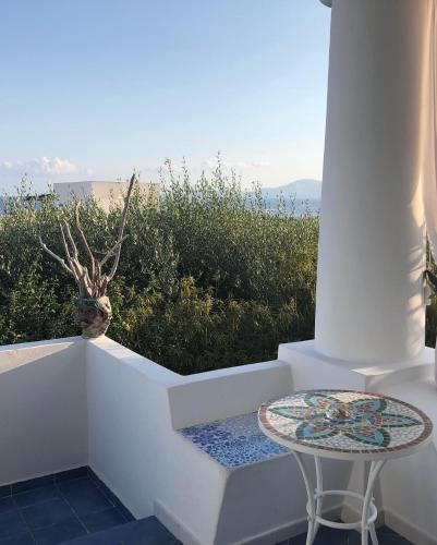 a table and a stool sitting on a set of stairs at La Sirena in Panarea