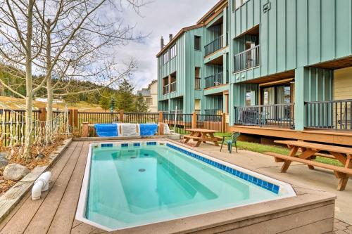 a swimming pool with a picnic table and a building at Ski-InandSki-Out Copper Mountain Condo with Balcony! in Copper Mountain