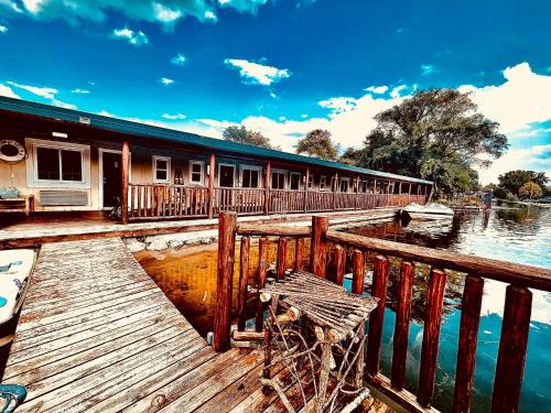 a building on a dock next to a body of water at Olde Mill Inn of Clarkston in City in the Village of Clarkson