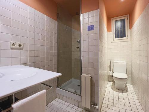 a bathroom with a toilet and a sink and a shower at Stay U-nique Apartments Borbó in Barcelona