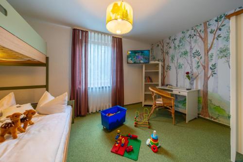 a bedroom with a bed and a desk and a table at Landhotel Salmen in Oberkirch
