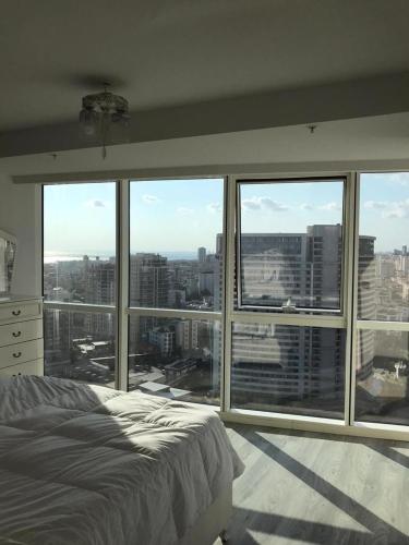 a bedroom with a large window with a view of a city at MANDRAKE in Istanbul