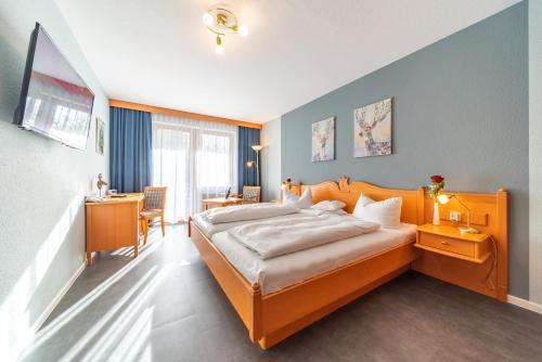 a hotel room with a bed and a desk at Landhotel Salmen in Oberkirch