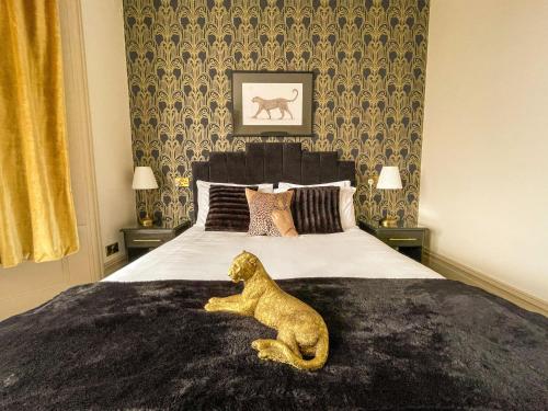 a dog laying on a bed in a bedroom at Timbertop Suites - Adults Only in Weston-super-Mare