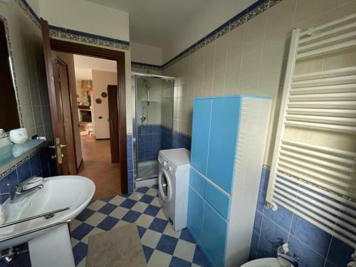 a bathroom with a toilet a sink and a washing machine at Dreamy home in Ateleta